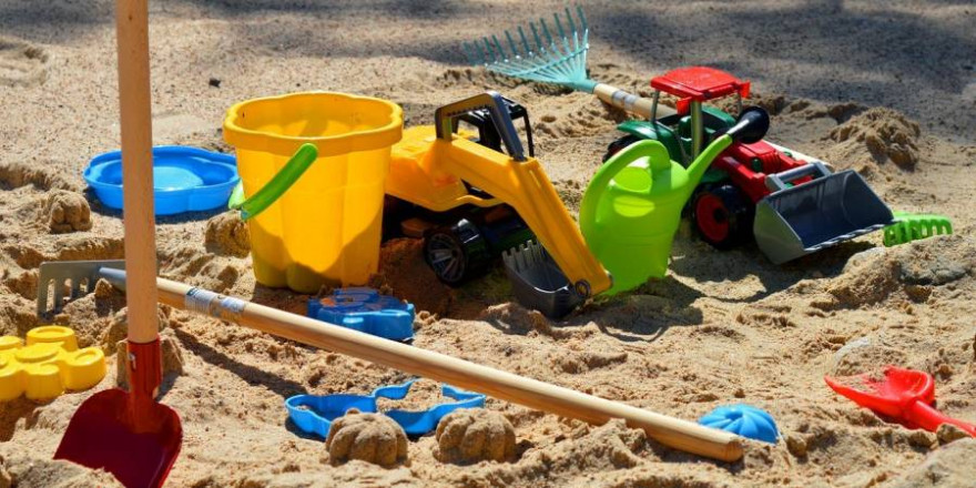 Diverse Kinderspielzeuge im Sand (Symbolbild: Frauke Riether)